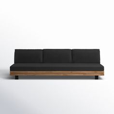 a black couch sitting on top of a wooden frame