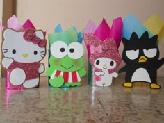 hello kitty and other paper crafts are lined up on the counter top with each other