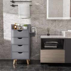 a bathroom with a sink, mirror and drawers in grey tones on the counter top