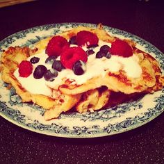 a plate topped with french fries covered in fruit