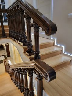 an ornate wooden staircase with handrails and railing