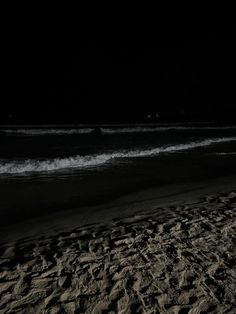 there is a surfboard on the beach at night