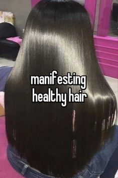 the back of a woman's head with long black hair that says, manfesting healthy hair