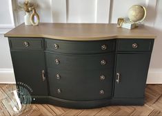 a black dresser with gold handles and knobs