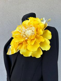 a black suit with a yellow flower on it