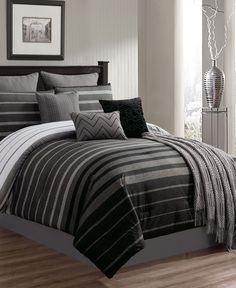 a bed with black and white striped comforters