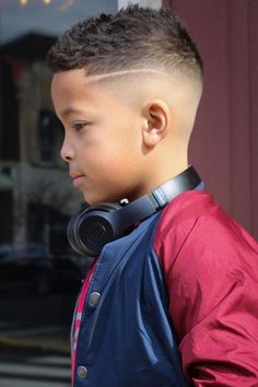 Gelled Haircut With A Skin Fade boyshaircuts haircutsforboys blackboyshaircuts Check out the coolest black boys haircuts we have put together in our galleryHere you will find a short curly hair mohawk with a fadea low taper with curlswaves with a side part and many other trendy hairstyles for kidsmenshaircuts menshairstyles Undercut Afro, Kids Hairstyles Boys, Black Hair Afro