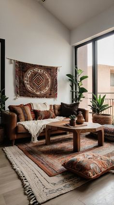 a living room filled with lots of furniture and plants in front of a large window