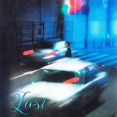 blurry photograph of cars driving down a street at night with the word lost written on it