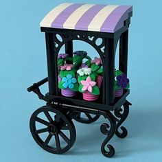 a toy carriage with flowers in it on a blue background