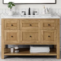 a bathroom vanity with two sinks and a mirror above it in a white tiled room