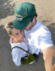 a man and woman taking a selfie in the middle of an open parking lot