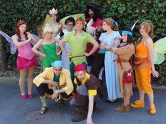 a group of people dressed up as peter pan and tinkerbells pose for a photo