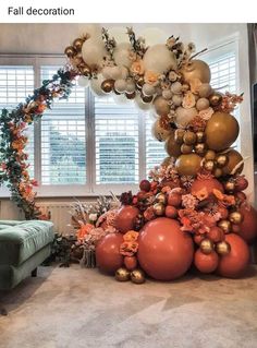 an arrangement of balloons and flowers in a living room