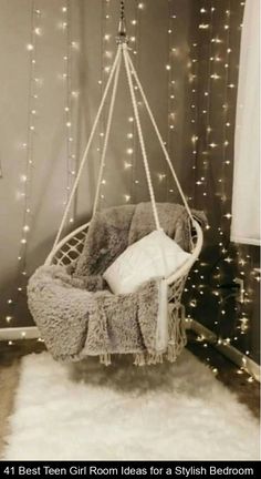 a hanging chair with lights in the background