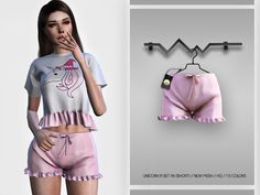 a woman wearing pink shorts and a top with an unicorn on it, standing next to a hanger