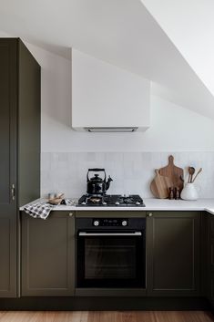 a stove top oven sitting inside of a kitchen next to a wooden counter tops and cabinets