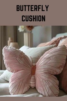 a pink butterfly pillow sitting on top of a bed with the words, how to make a butterfly cushion