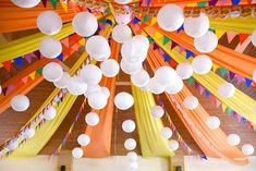 the ceiling is decorated with paper lanterns and streamers