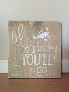 a wooden sign that says oh the places you'll go with an airplane on it