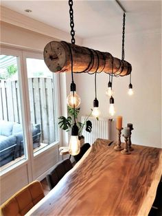 a wooden table with lights hanging from it