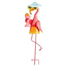 a pink flamingo standing on top of a metal stand with a hat on it's head