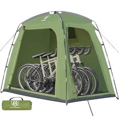 a green tent with three bikes in it