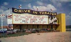 an old drive in theater with cars parked outside