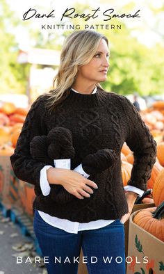 Lady wearing a hand-knitted wool sweater with intricate cable patterns, showcasing the texture and warmth of the yarn. Smock Pattern, Dark Roast, Garter Stitch, Split Hem, The Coffee