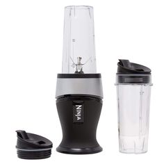 a blender sitting on top of a white table next to a shaker bottle