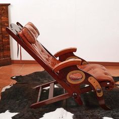 a chair that is sitting on top of a cowhide rug