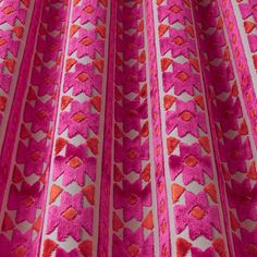 a pink and red fabric with hearts on the side is shown in close up view