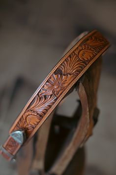 a leather belt with an intricate design on it