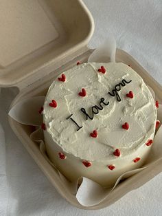 a birthday cake with the words i love you written on it in an open box