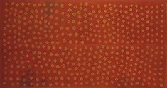 an orange and yellow painting with gold dots on it's edges, in front of a red background