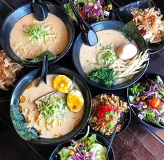 several bowls of food are arranged on a table