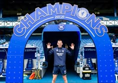 a man standing in front of a stadium entrance