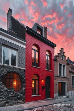 a red brick building sitting on the side of a street next to tall buildings with windows