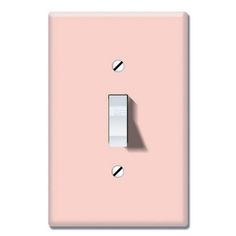 a pink light switch cover with a shadow on it