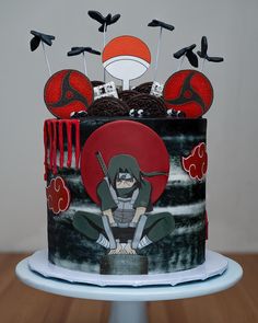 a decorated cake with an anime character on it's side and forks sticking out of the top