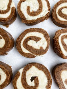 there are many cookies with white frosting in the shape of a spiral on top