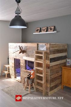 a loft bed made out of wooden pallets in a child's room with bunk beds