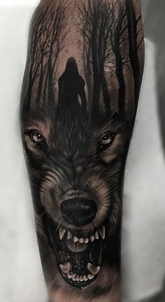 a man with a wolf tattoo on his arm