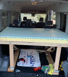 the back end of a van with its cargo compartment open and tools on the floor