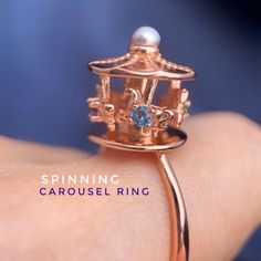 Spinning Carousel Ring lovingly designed by Love Estella Jewelry This delightful ring features a whimsical spinning carousel that brings a touch of childhood wonder to your everyday style. The carousel is beautifully crafted with intricate detailing and set with natural gemstones that create a truly enchanting effect. It is perfect for anyone who loves unique and playful jewelry and is sure to be a conversation starter wherever you go. Add a touch of magic to your accessory collection with this Mystical Gemstone Rings For Collectors, Carousel Jewelry, Luxury Mystical Collectible Rings, Elegant Iridescent Crystal Ring Adjustable, Astrological Sphere Ring, Playful Jewelry, Spinner Rings, Damascus, London Blue