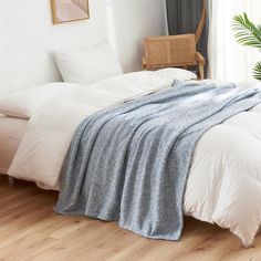 a bed with two blankets on top of it