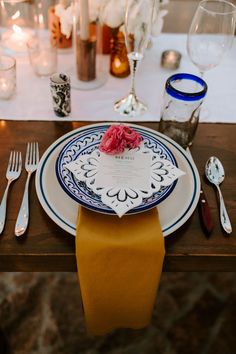 a table set with plates, silverware and napkins for an elegant wedding reception