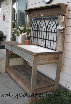 a wooden bench sitting on the side of a house