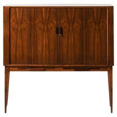 the sideboard is made out of wood and has two doors on each side, one door