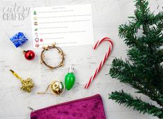 the contents of a christmas ornament laid out on a white table with candy canes and other holiday decorations